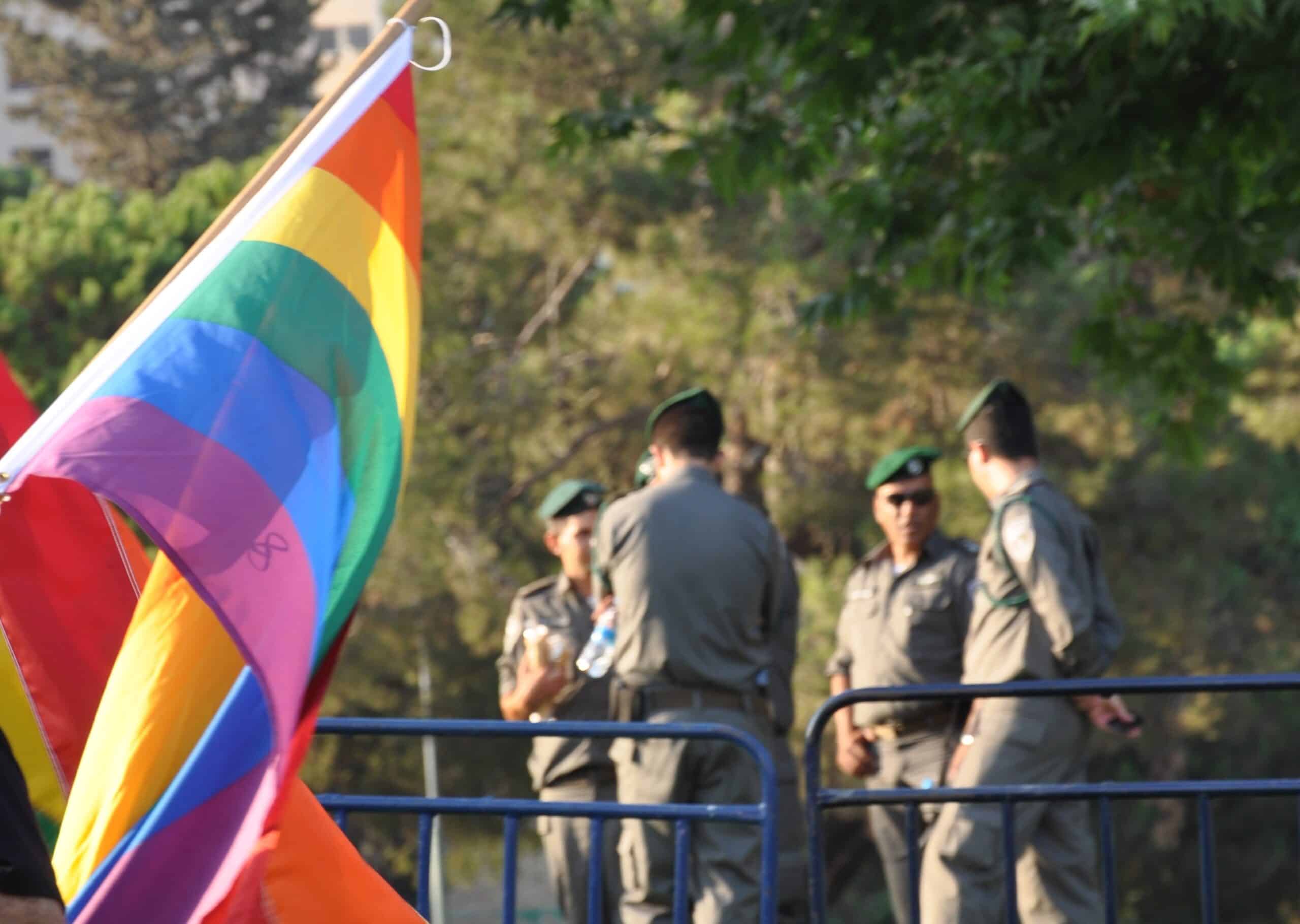 Soldiers next to a pride flag, LGBT, rainbow