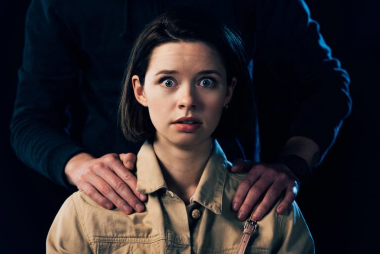 Cropped view of criminal attacking scared woman