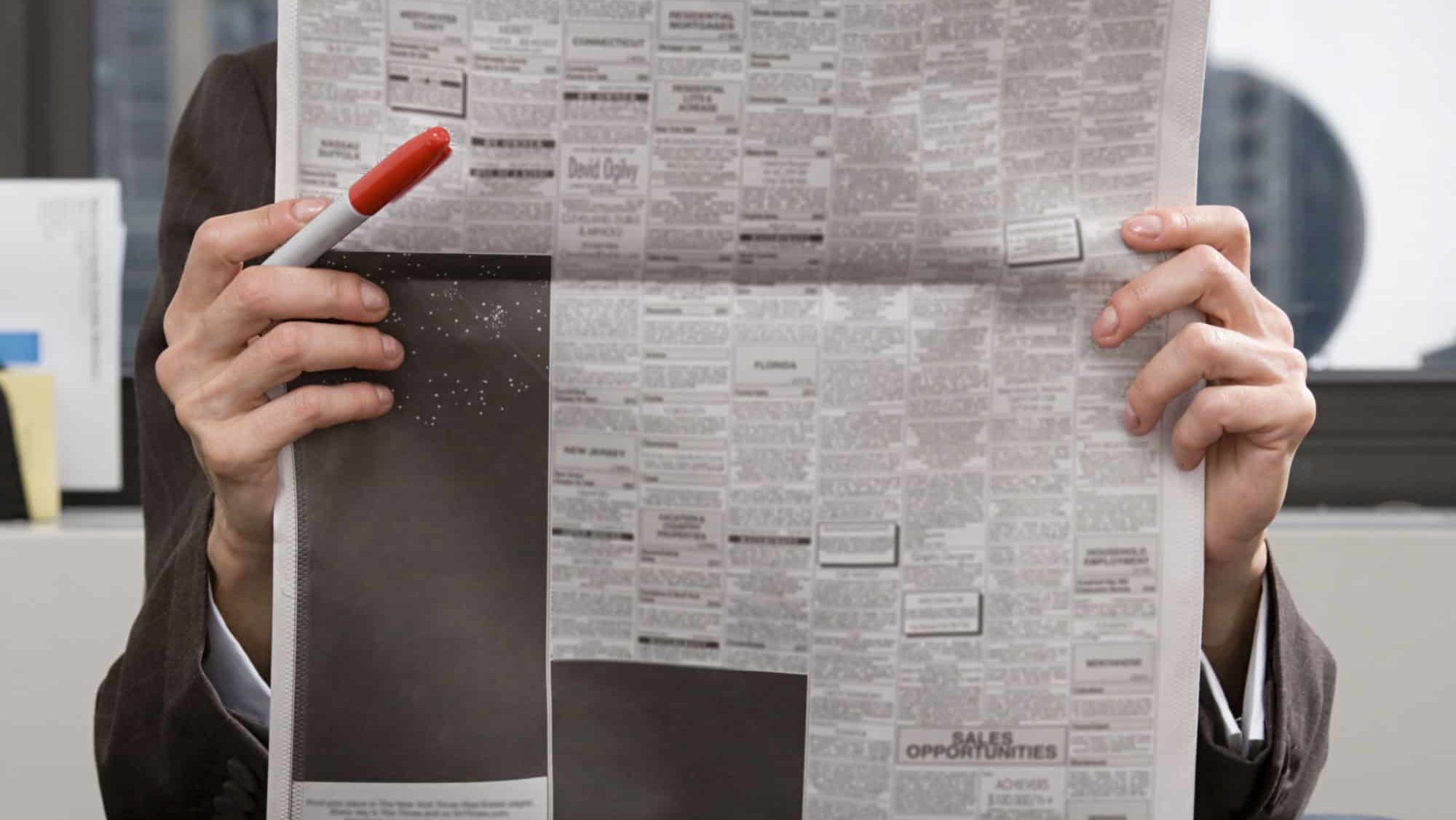 Person looking at newspaper