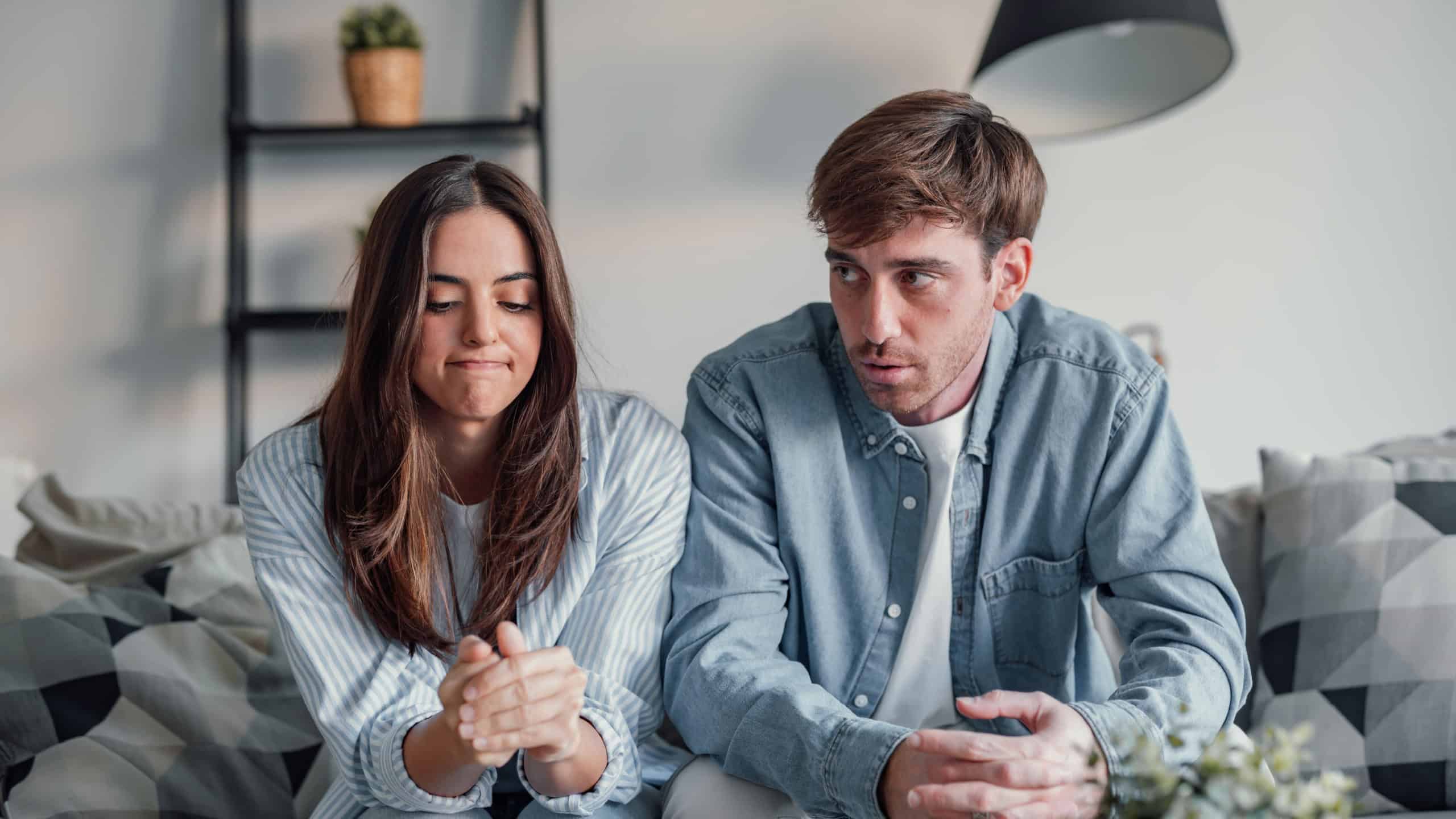 Young couple arguing and talking to the camera in videocall conference with specialist about relationship problems difficulties. Sad and angry man and woman arguing indoor debating future