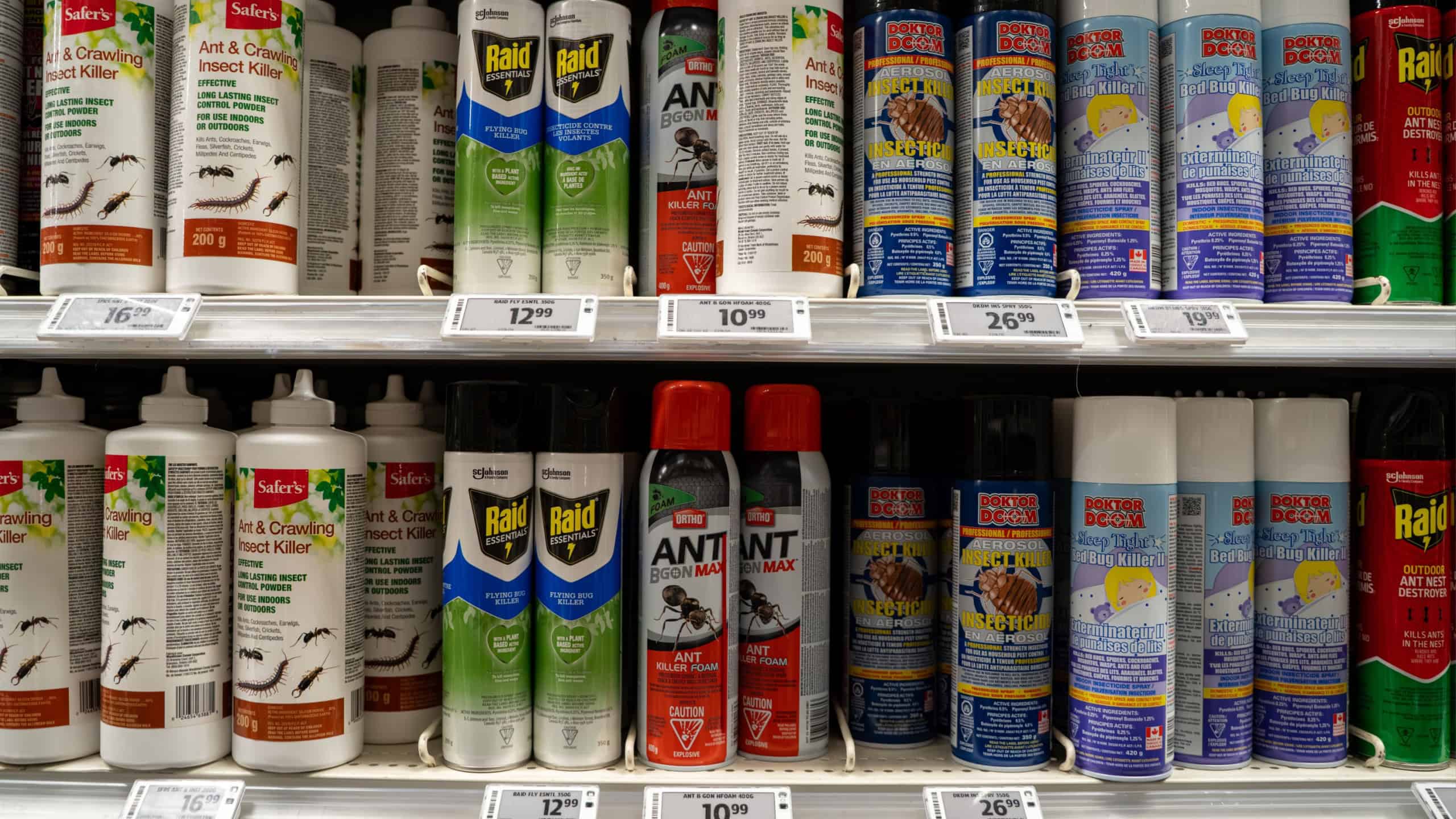 Shelf with insect killer sprays and ant control powders in store