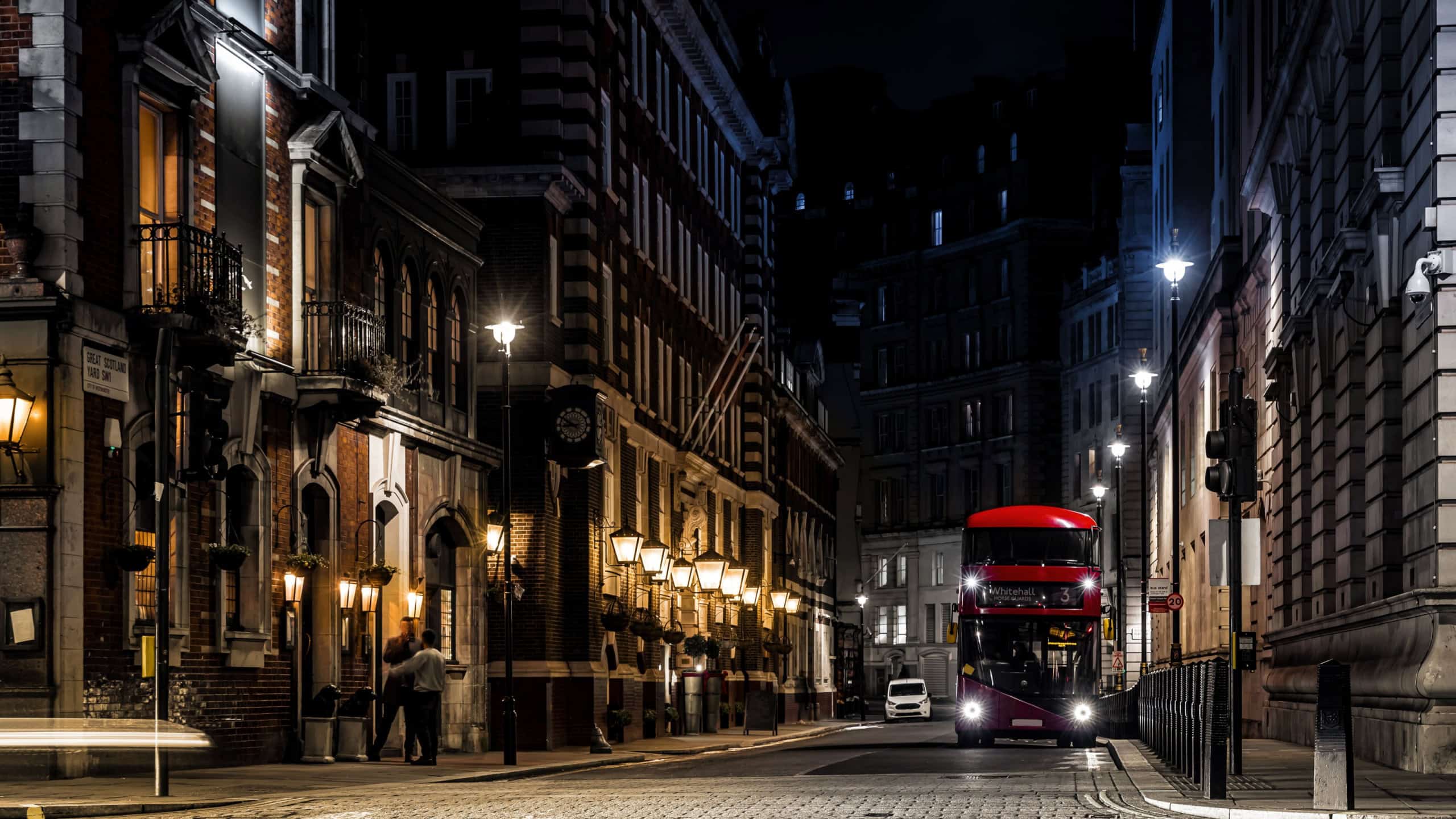 A red double decker in the night on Parliament street in London, UK