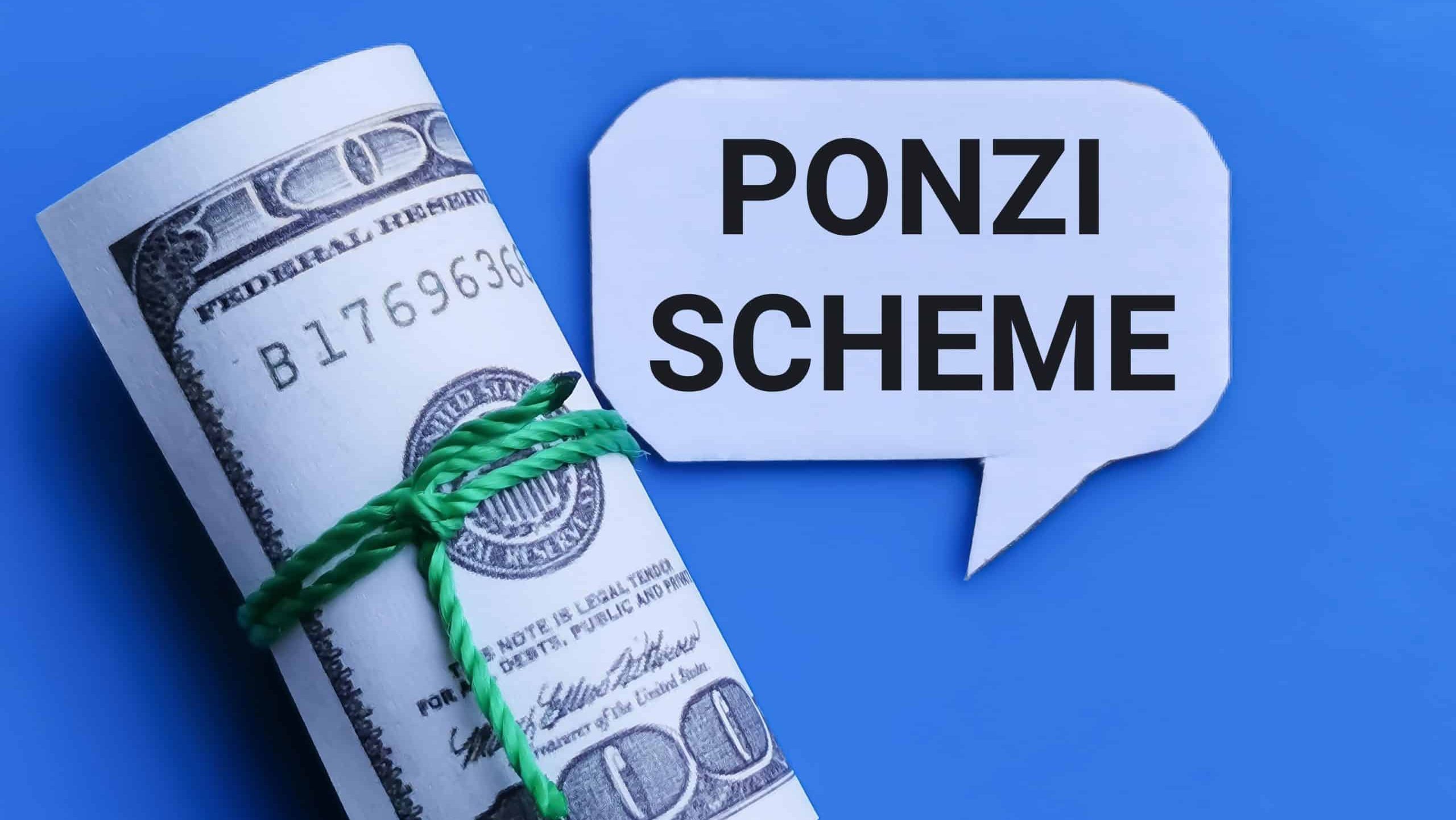 Business and finance concept. Phrase PONZI SCHEME written on bubble speech with fake money.