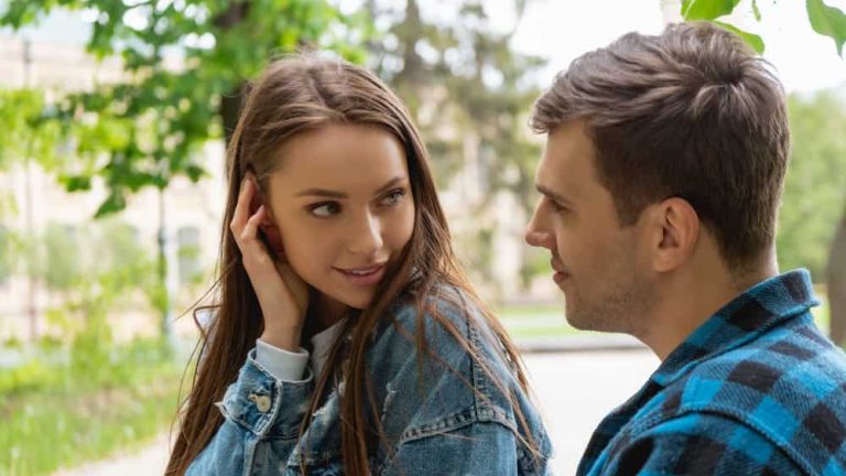 pretty girl touching hair while flirting with boyfriend